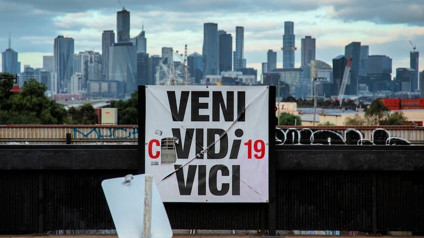 An altered sign outside Melbourne reading "Veni Covidi-19 Vici"