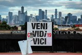 An altered sign outside Melbourne reading "Veni Covidi-19 Vici"