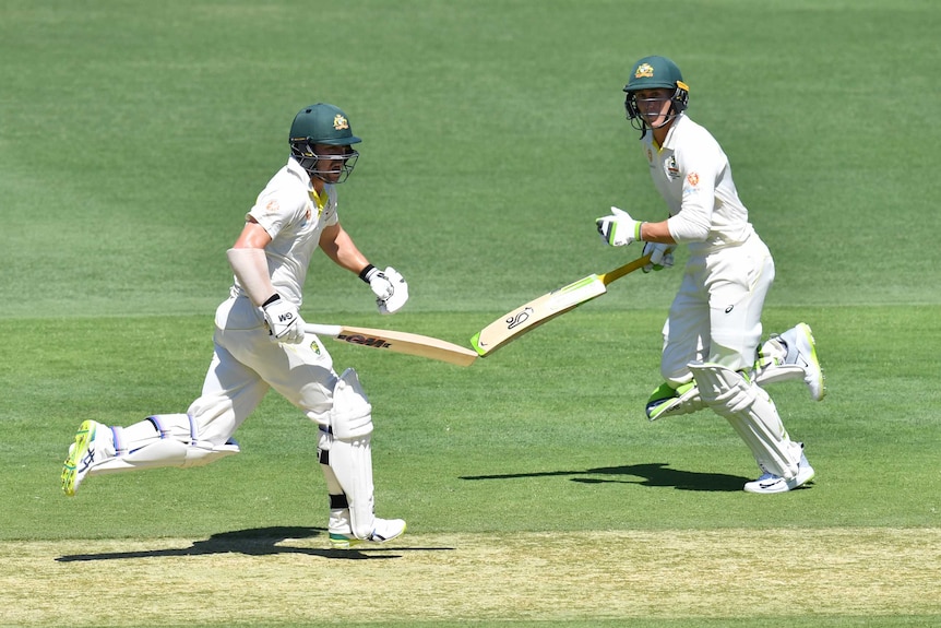 Australia batsmen Travis Head and Marnus Labuschagne run between wickets during a Test against Sri Lanka at the Gabba.
