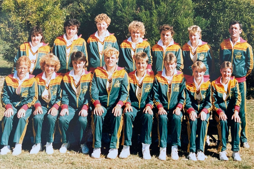 A group photo of a sports team in the 1980s wearing green and yellow
