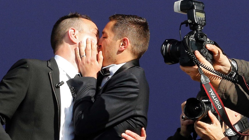 Vincent Autin and Bruno Boileau kiss after their marriage.