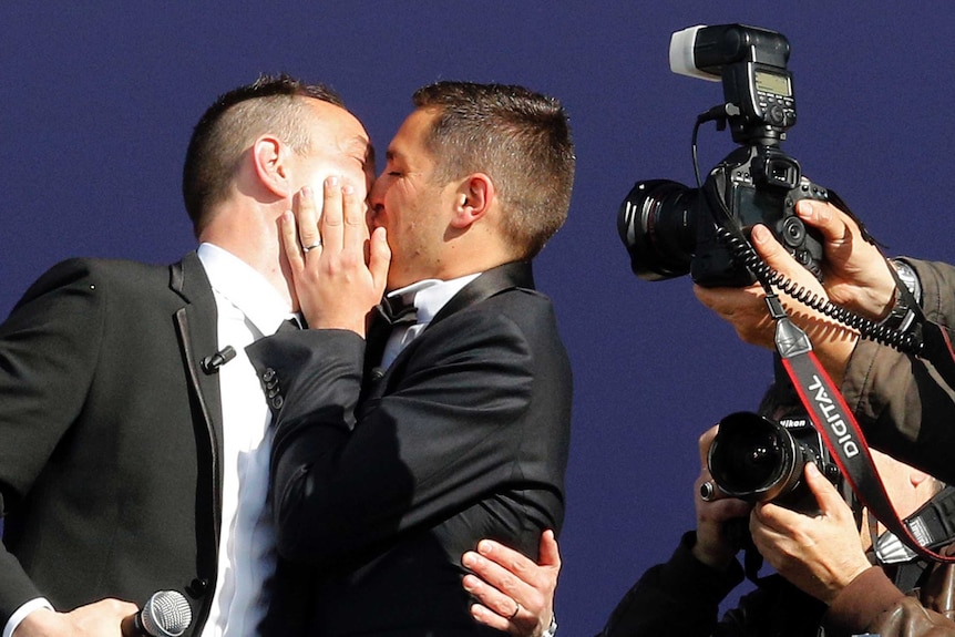 Vincent Autin and Bruno Boileau kiss after their marriage.