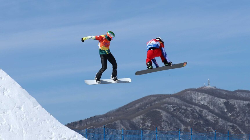 Jarryd Hughes in mid-air during his heat of the men's snowboard cross at the Olympic Winter Games.