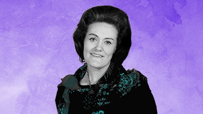 A black-and-white photograph of Dame Joan Sutherland with turquoise highlights on a purple background