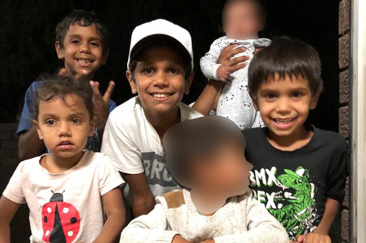 A group of young children pose smiling for a photo.