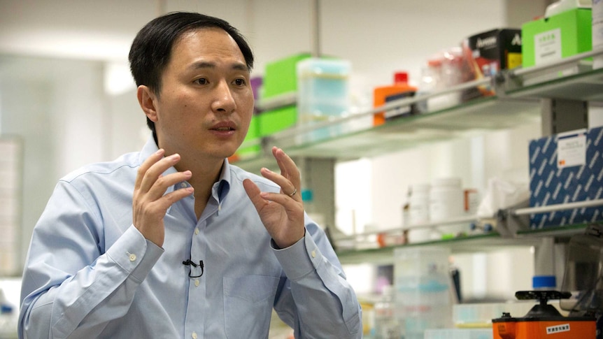 He Jiankui gestures with his hands while speaking during an interview.