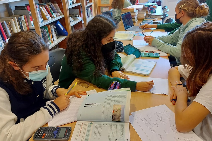 students wearing masks studying