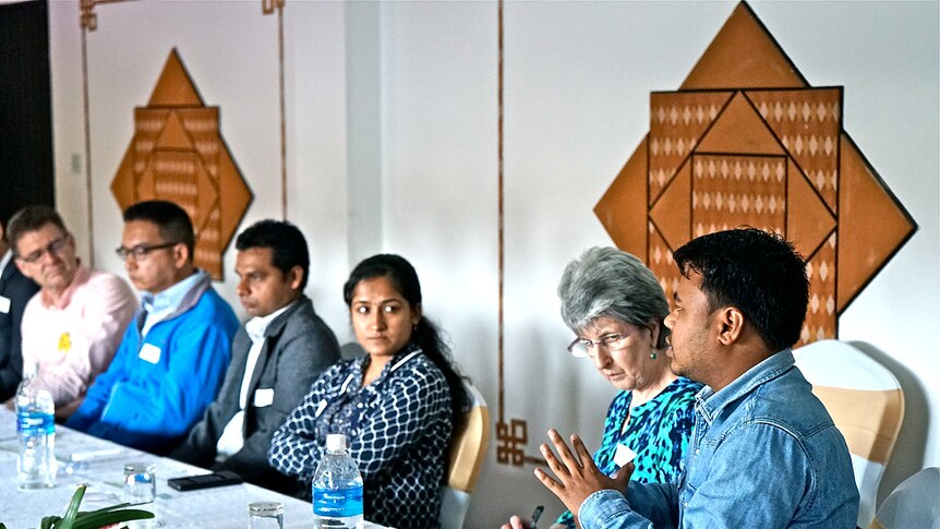 Australian and Nepalese people sitting around a conference table