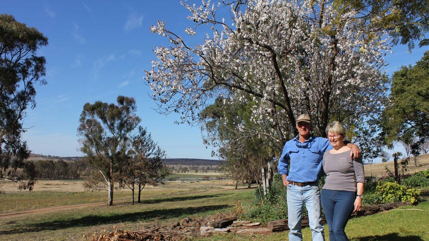 Fire-affected property owners Kathy and Saxon McGregor standing in their garden