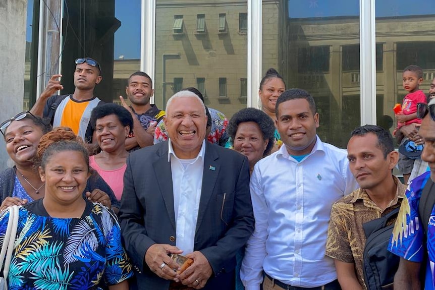 Frank Bainimarama with supporters outside court in Suva on Friday.
