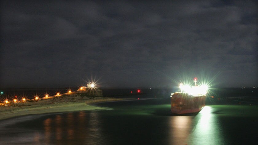 Night photo of ship stuck on sand bank