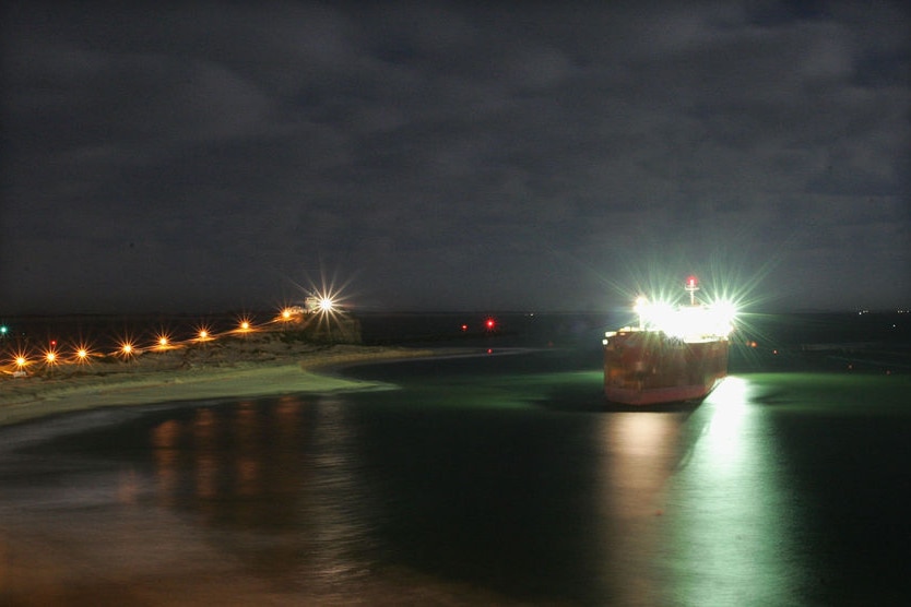 Night photo of ship stuck on sand bank