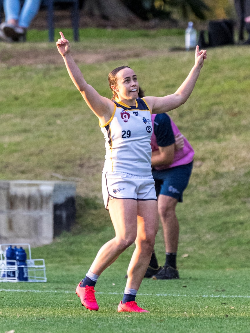 Lydia Pingel with hands up in celebration after playing AFL for Bond University