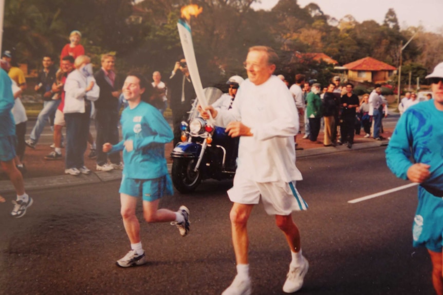 Sydney teacher Allan Jones runs with the torch across the Roseville Bridge in 2000.
