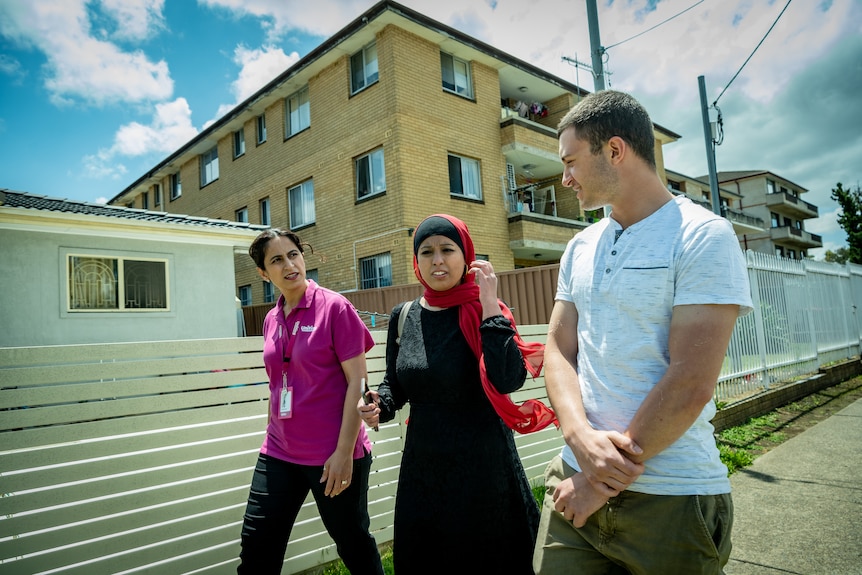 Catherine Matloub, Huma Naz and Ethan Jabbor talking and walking along the street.