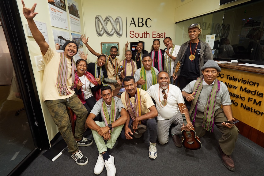 Group of East Timorese singers posing for a group shot smiling in an ABC studio
