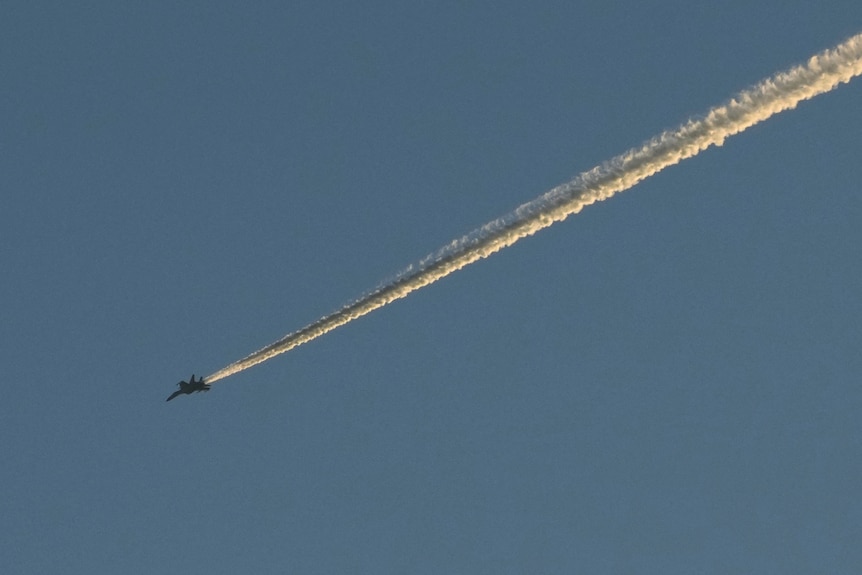 A Chinese People's Liberation Army (PLA) aircraft flies in the sky 