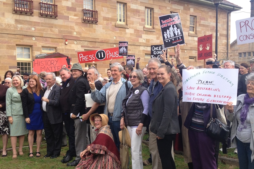 Protestors holding placards at the Parramatta heritage site