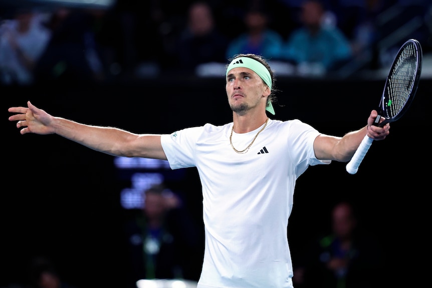 Alex Zverev puts his arms out in celebration during an Australian Open semifinal.