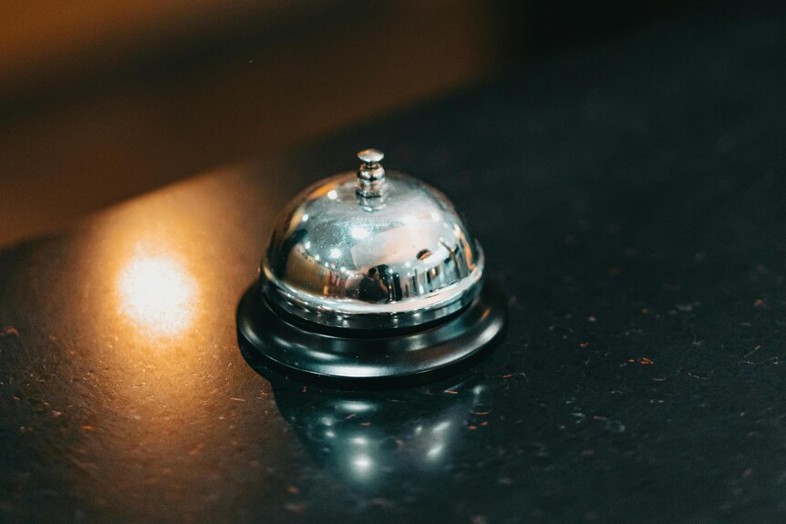 A small bell on a desk.