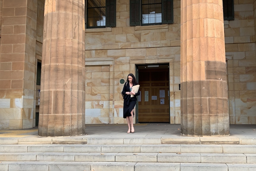 A lawyer walks down the steps of the Adelaide Magistrates Court.