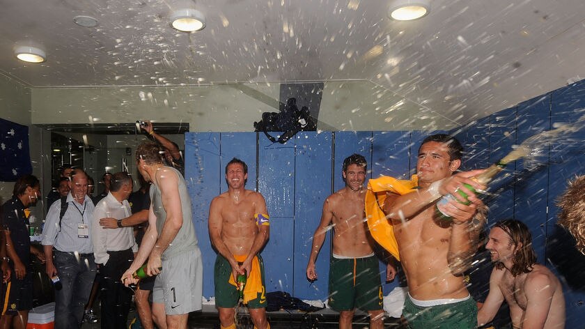 Tim Cahill kicks off the celebrations in the dressing rooms.