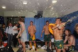Tim Cahill kicks off the celebrations in the dressing rooms.