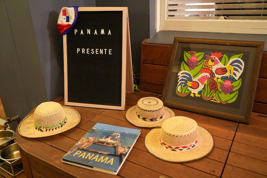 Three Panama hats sit on a wooden box.