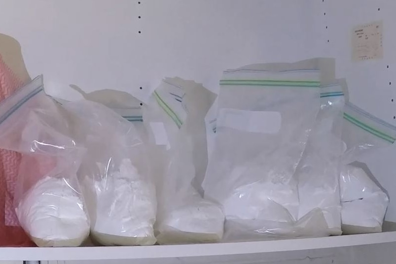 Several large ziplock bags filled with white powder.
