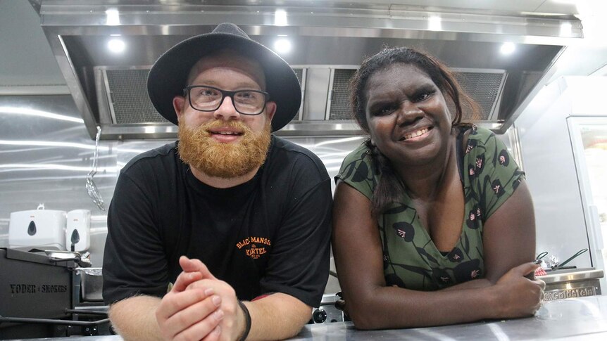 A photo of Zach Green and Elijah Gurruwiwi leaning on the counter of their pop-up restaurant.