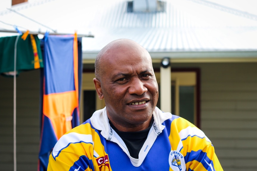 Portrait of a man in his 40s, wearing a yellow and blue jersey.