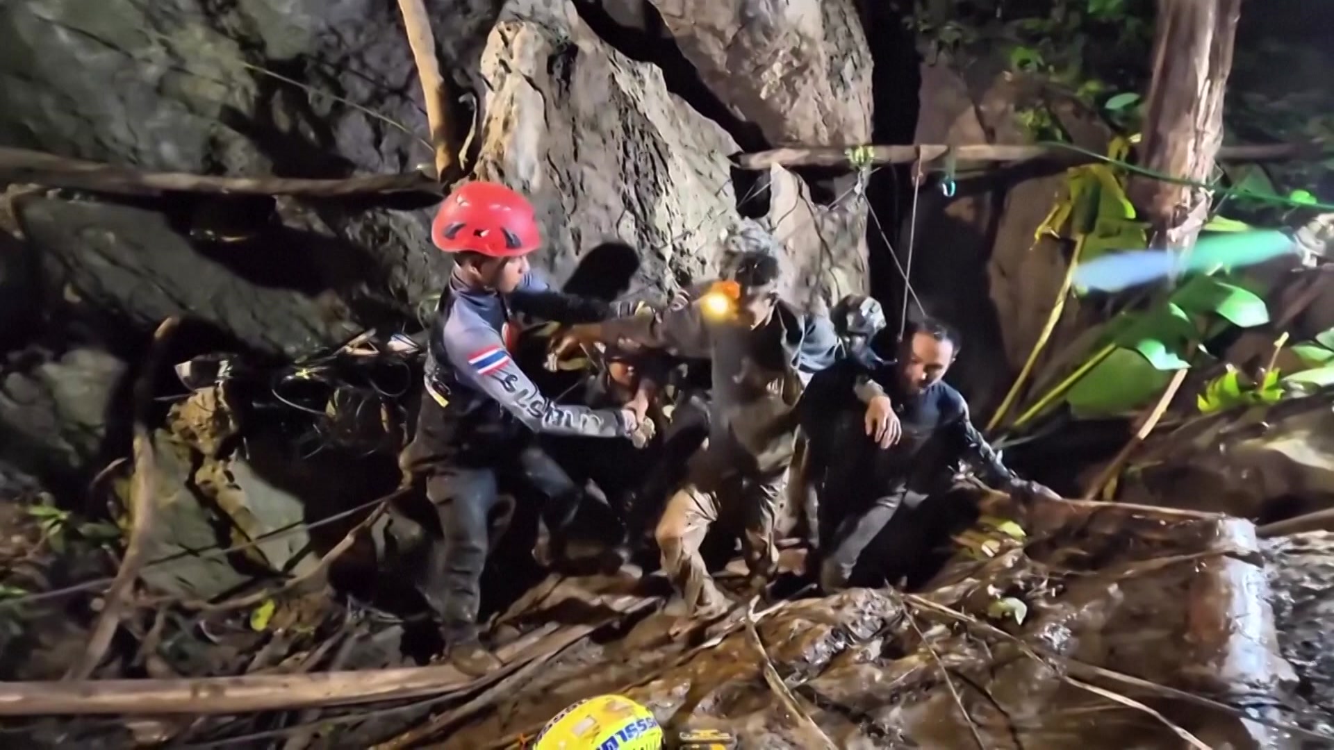 Rescuers pull out person from cave. 