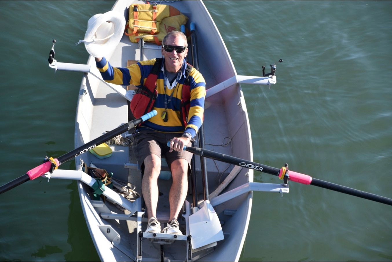a man aged in his 70s rowing in a kayak.