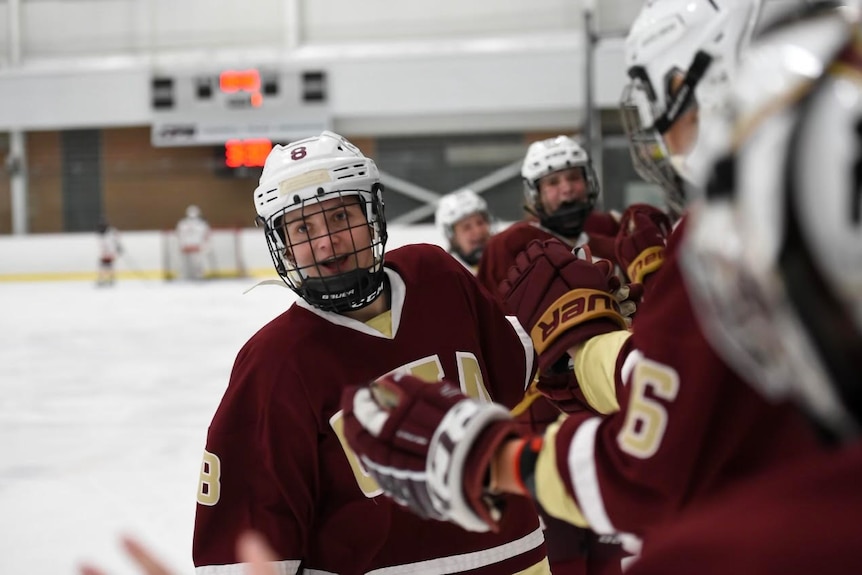 Ice hockey player Courtney Mahoney in full uniform, smiling