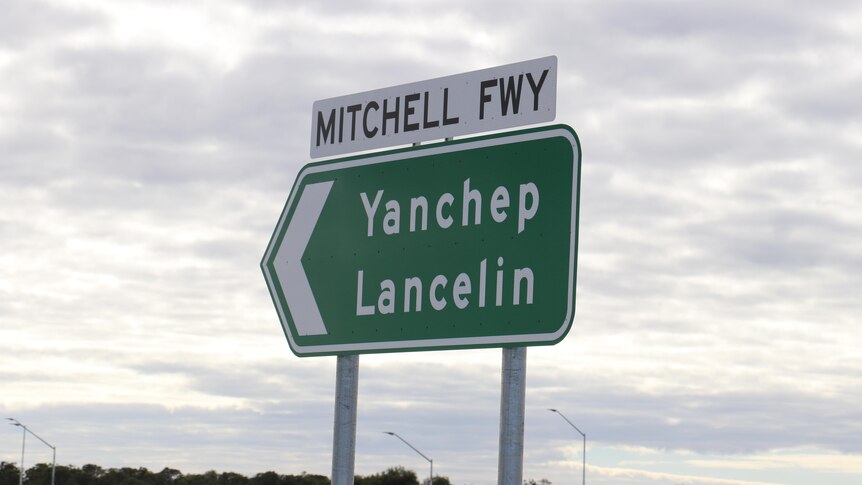 A sign that says 'Mitchell Freeway'.