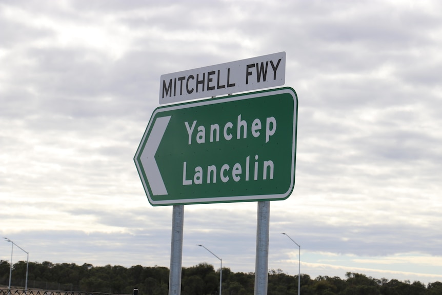 A sign that says 'Mitchell Freeway'.