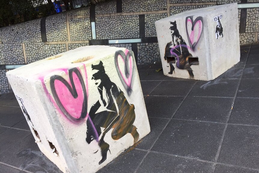 Street art painted on security bollards in Southbank in Melbourne.
