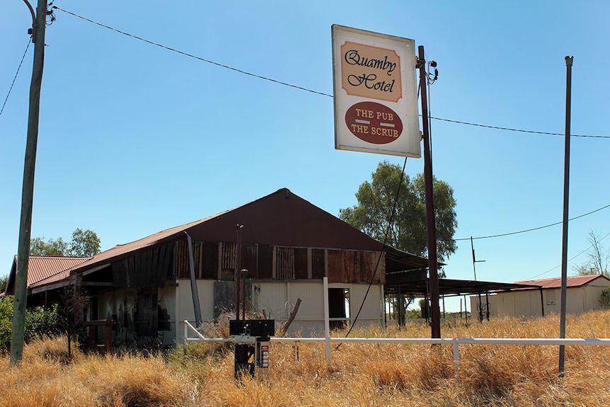 A rusty rundown pub, with a sign reading, 'The Pub, The Scrub'.