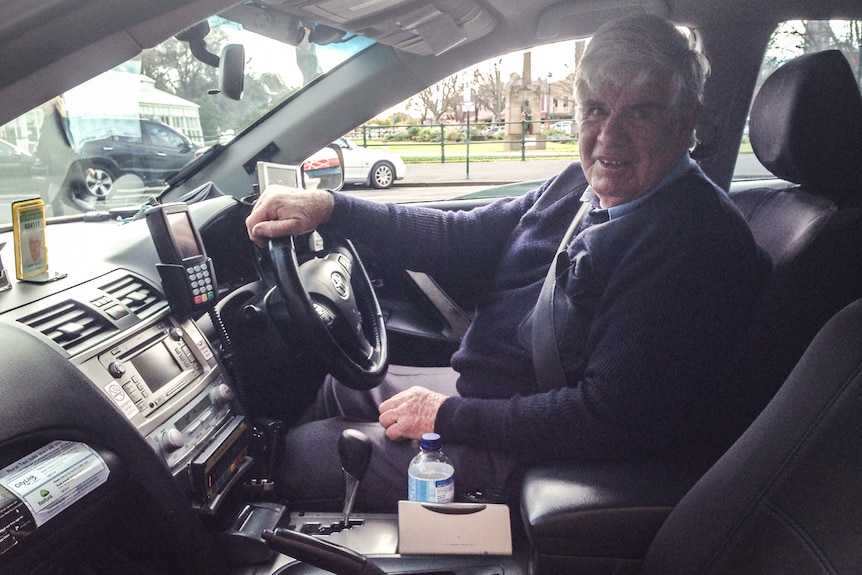 Driver Pat Holahan behind the wheel of his taxi