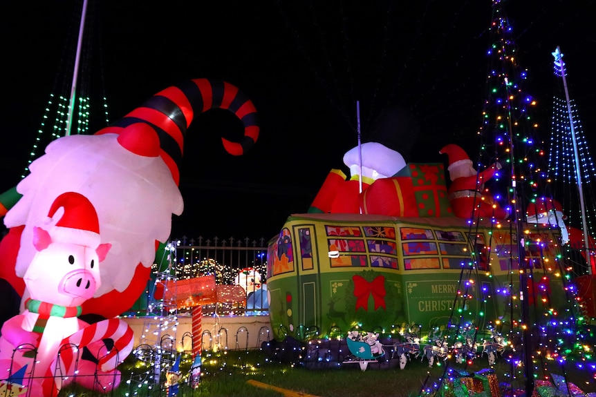 Several large inflatable lights, surrounded by other Christmas lights.