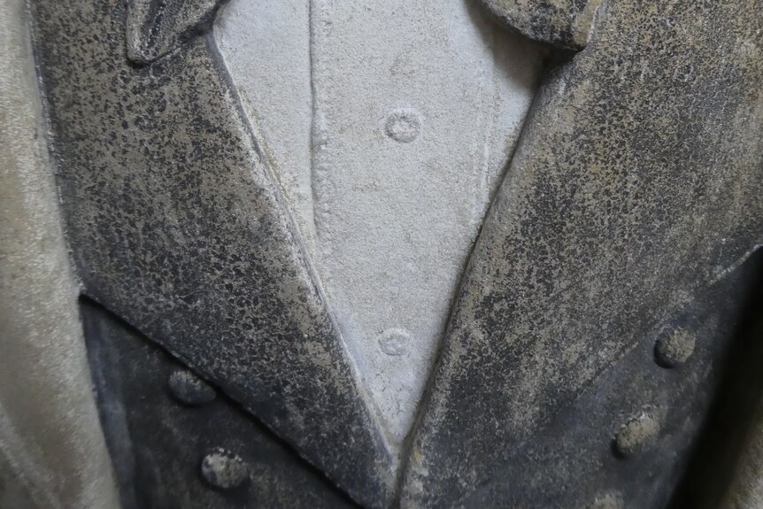 Close up of sculpture showing jacket and top.