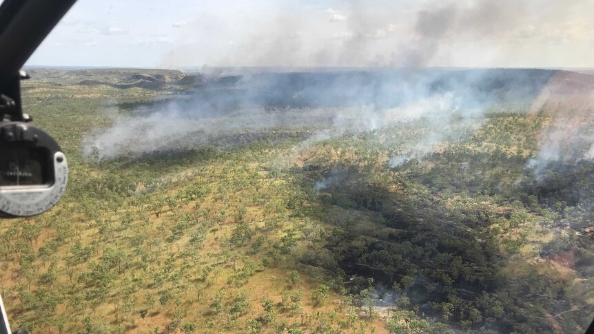 An aerial view of smoke and flames during early season burns at Nitmiluk National Park