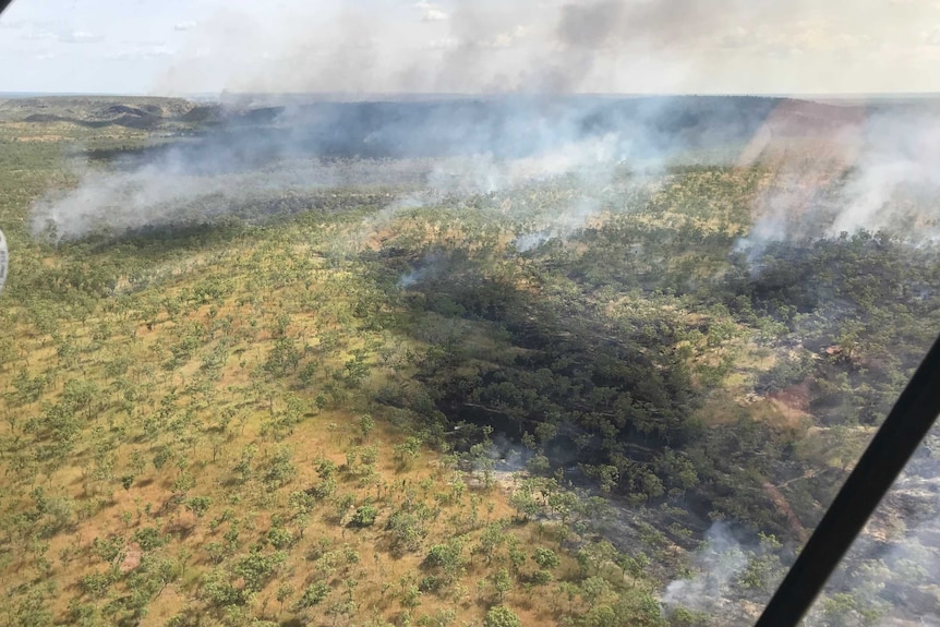 An aerial view of smoke and flames during early season burns at Nitmiluk National Park
