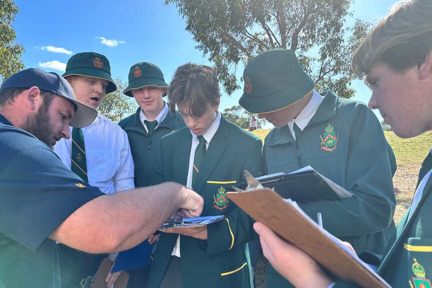 A group of students from Farrer Memorial Agricultural High School observe their readings. 