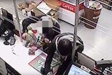 CCTV footage shows a teenager and man robbing a Canberra service station.