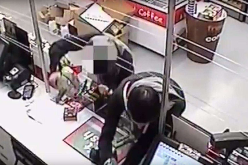 CCTV footage shows a teenager and man robbing a Canberra service station.