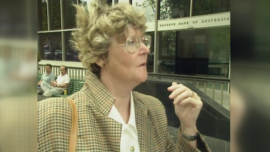 A retro-looking image of a woman talking outside of the Reserve Bank of Australia building