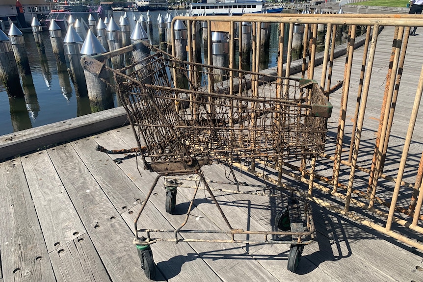 A rusted trolley on a river board walk.