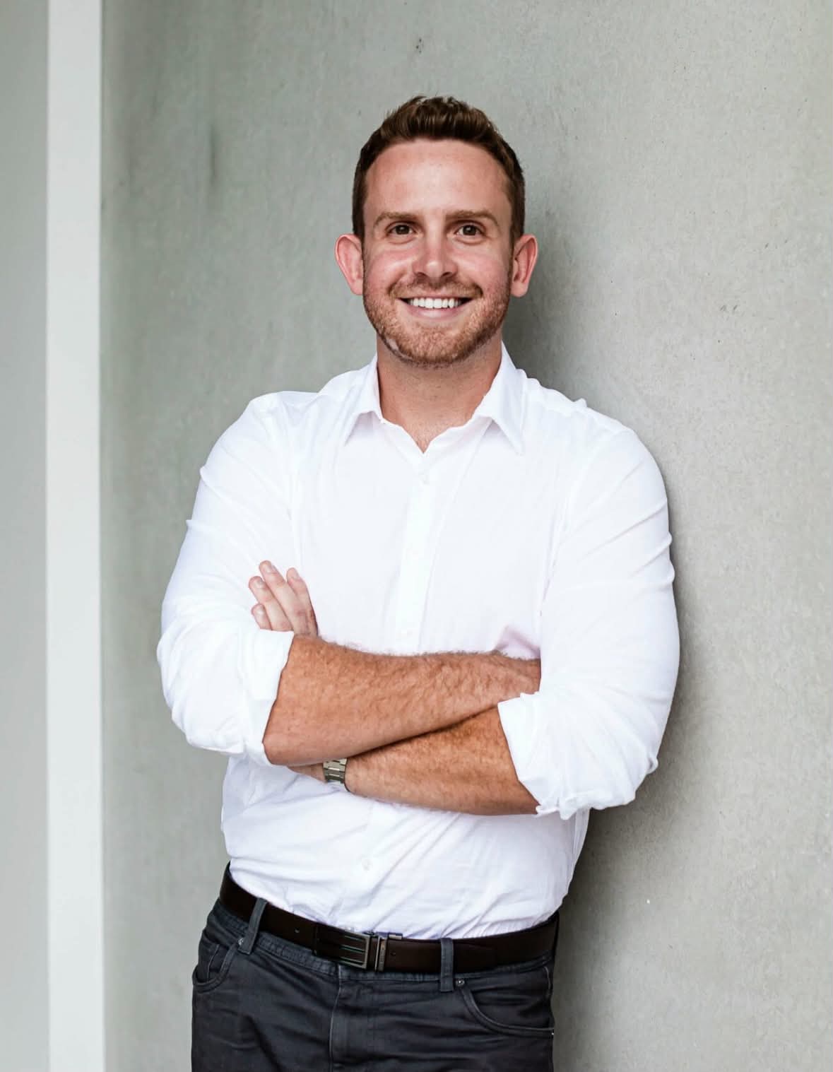 A 30-year-old man smiling at the camera