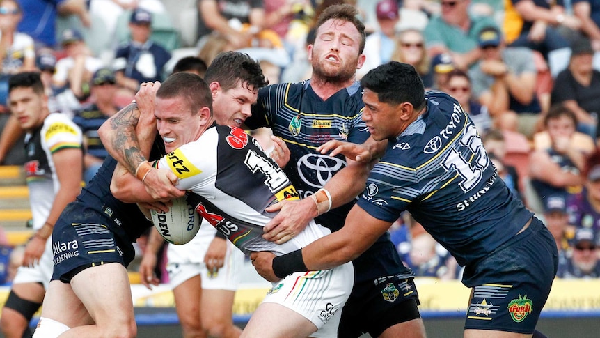 Panthers Tim Browne tackled by Cowboys defence in Townsville in June 2017.
